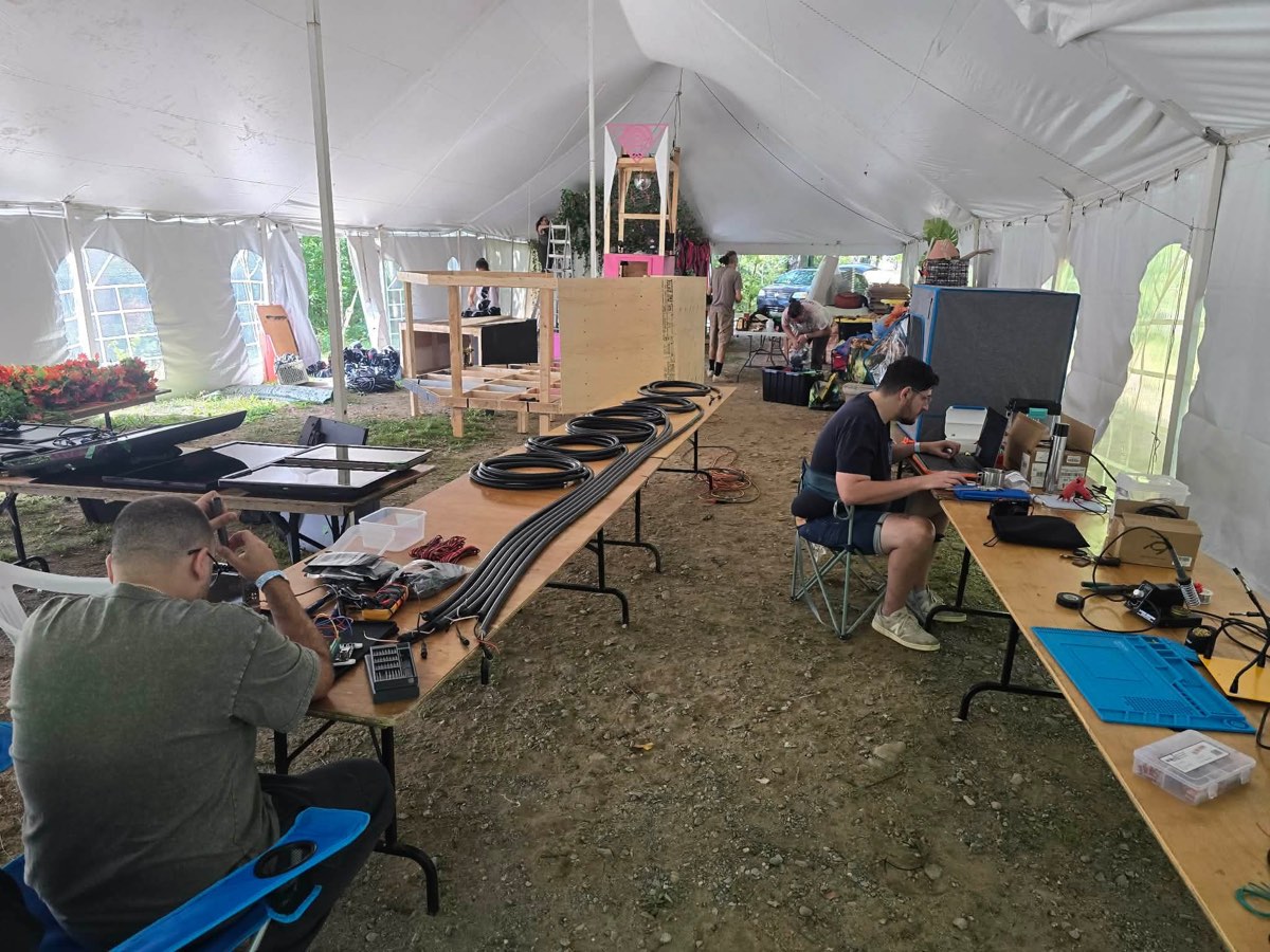 Six long tubes laid out on the tent floor for testing