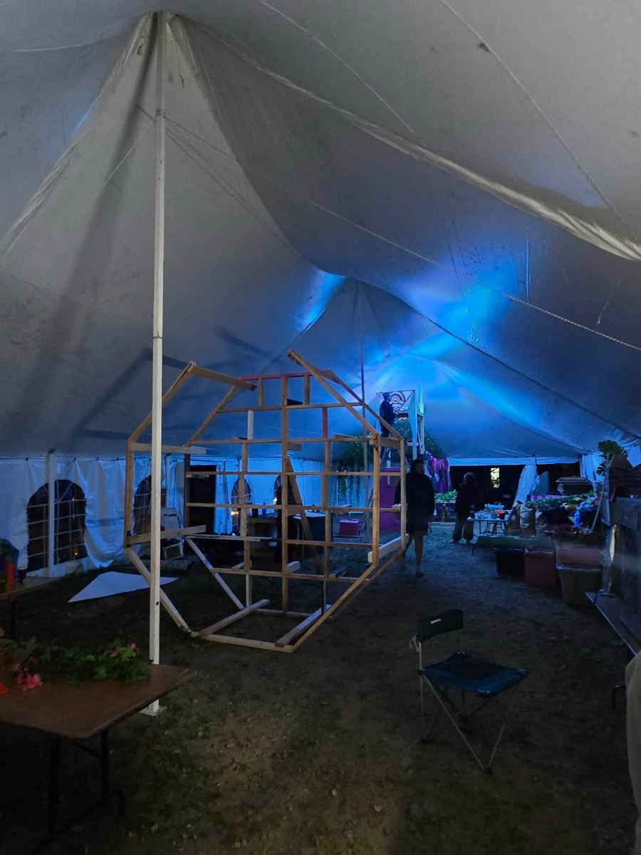 Timber stage frame inside the tent under blue light