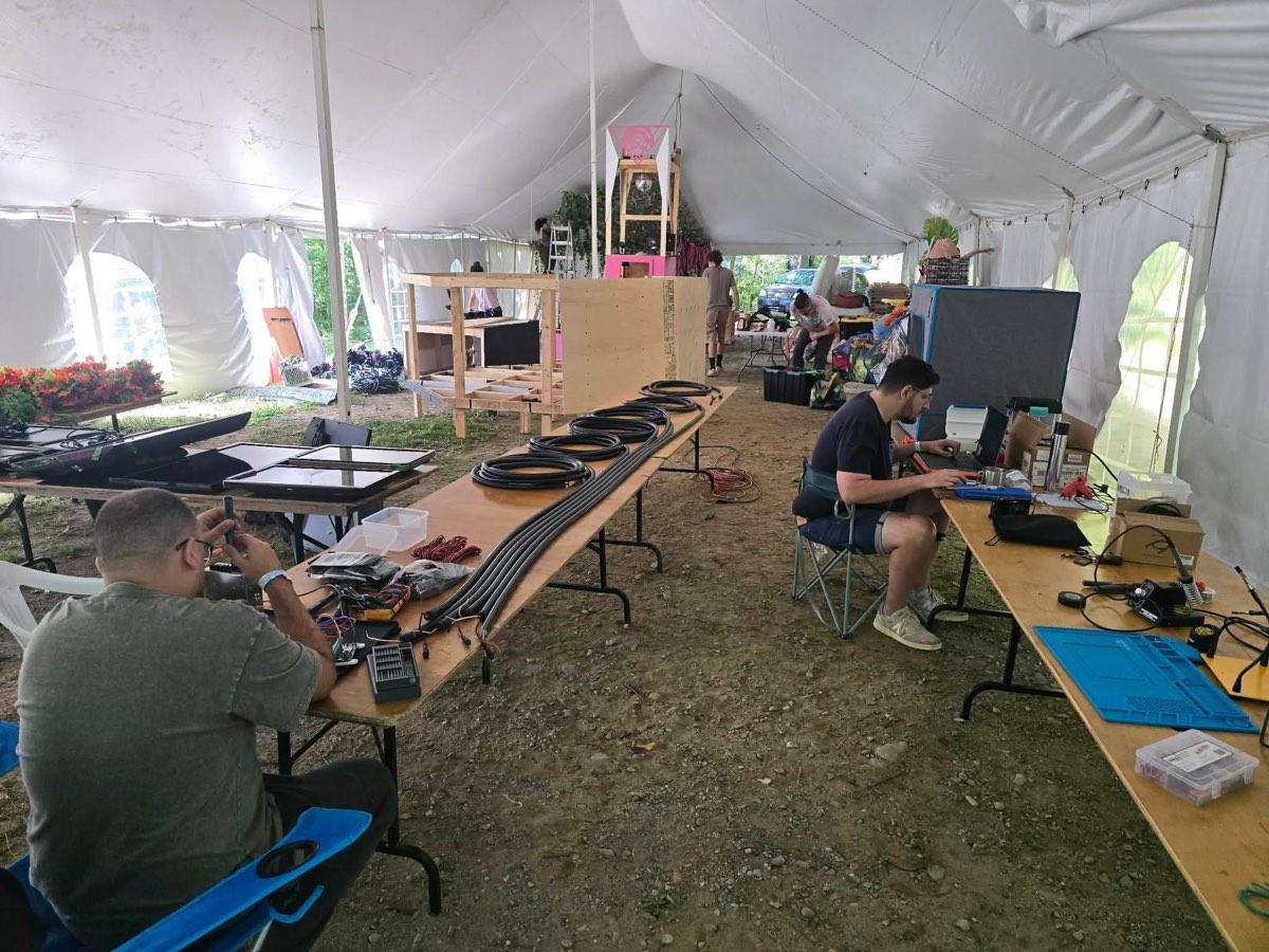The shared fabrication and electronics workspace inside the tent